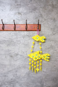 Directly above shot of yellow flowers against gray background