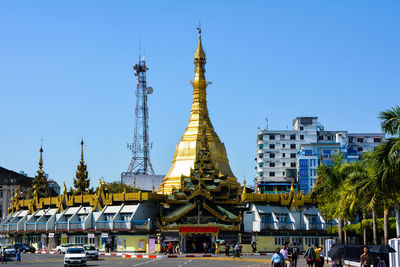 Crowd at temple against sky in city