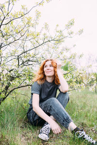 Young woman sitting on field