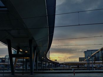 Low angle view of bridge against sky at sunset