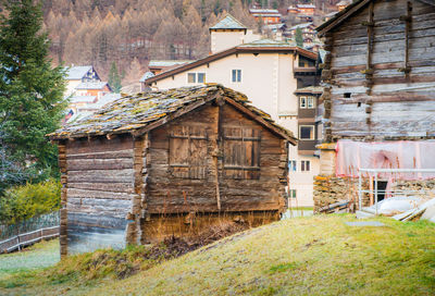 Old house amidst buildings on field