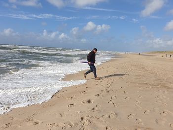 Full length of man on beach against sky