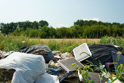 Big rubbish dump neare the road, nature and blue sky background