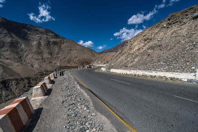 Road amidst mountains against sky