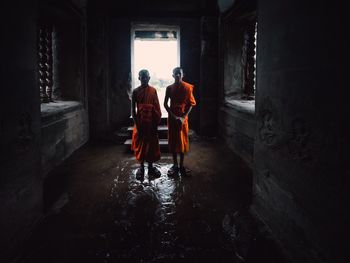 Rear view of people walking in building