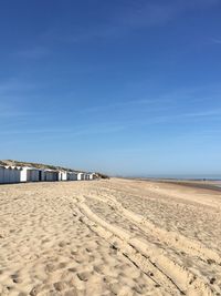 Scenic view of beach against blue sky