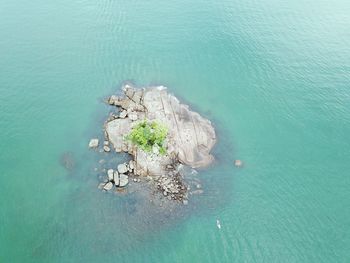 Aerial view of rock formations amidst sea