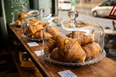 Selections of croissants in the glass display jars / on the plates