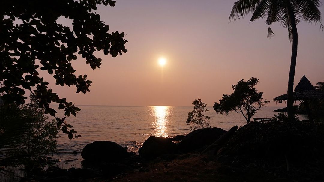 SCENIC VIEW OF SUNSET OVER SEA