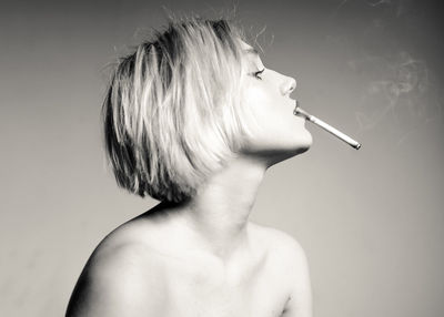 Portrait of woman smoking cigarette