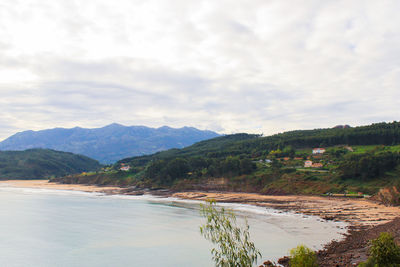 Scenic view of mountains against cloudy sky