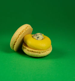 Close-up of yellow slices over green background