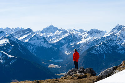 Rear view of man standing on mountain