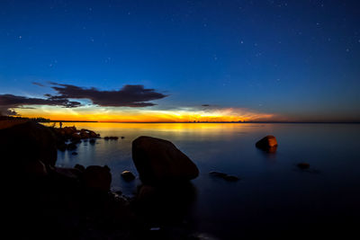 Scenic view of sea against sky at night