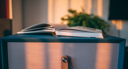 Close-up of open book on table at home