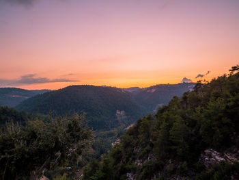 Scenic view of mountains against sky at sunset