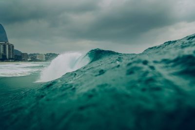 Scenic view of sea against cloudy sky