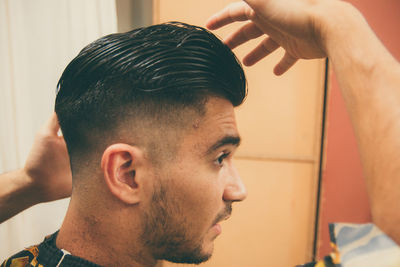 Barber setting hair of man in the barber shop