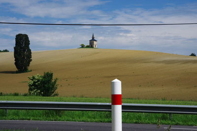 Built structure on field against sky