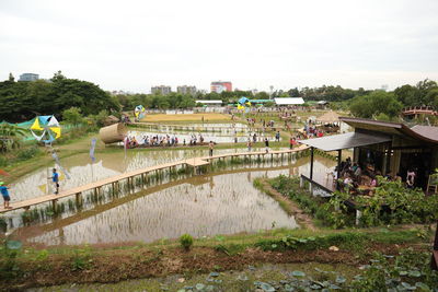 High angle view of river by buildings against sky