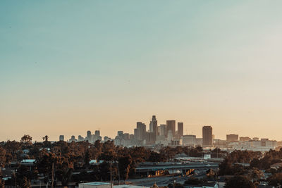 View of buildings in city against clear sky