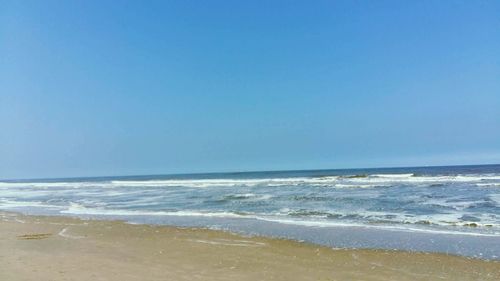 View of beach against blue sky