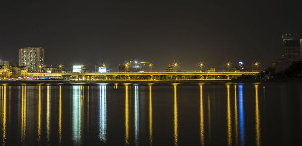 Illuminated city at waterfront