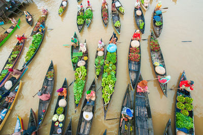 High angle view of people with fruits in boat sailing on river