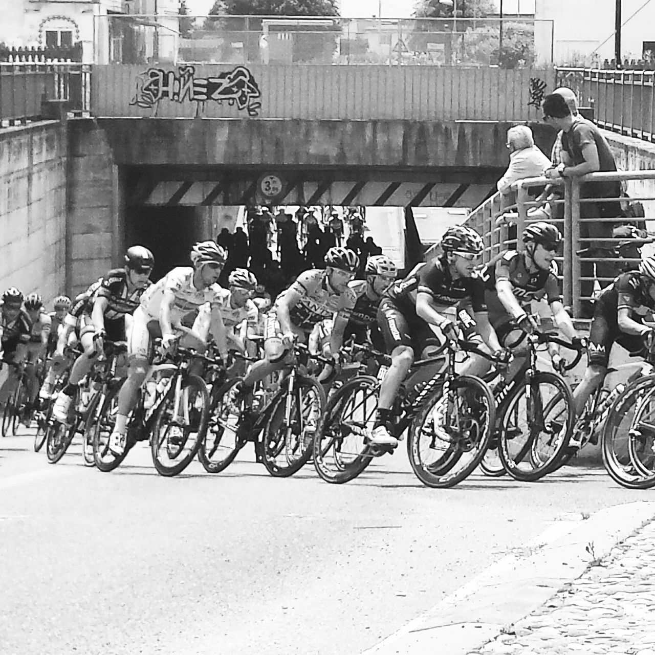 bicycle, transportation, land vehicle, mode of transport, building exterior, architecture, built structure, street, men, city, text, parked, stationary, parking, graffiti, outdoors, day, road, city life