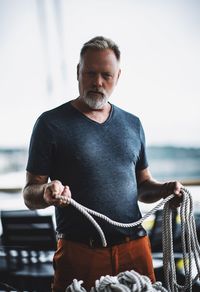 Portrait of man holding rope