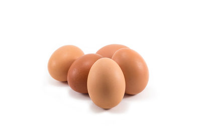 Close-up of eggs against white background