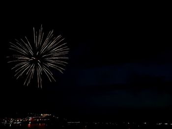 Low angle view of firework display at night