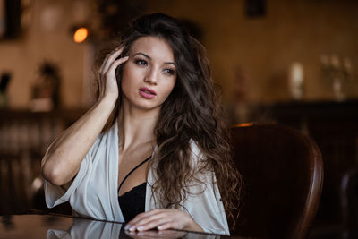 Portrait of beautiful woman sitting in restaurant