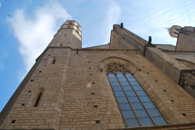 Low angle view of historical building against cloudy sky