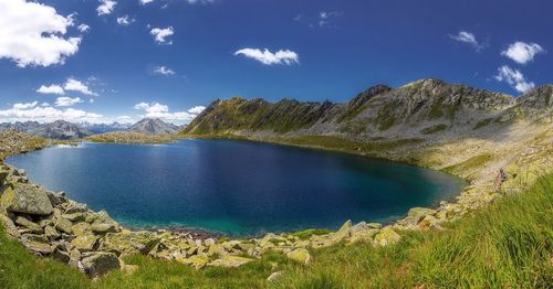 Scenic view of lake and mountains against sky