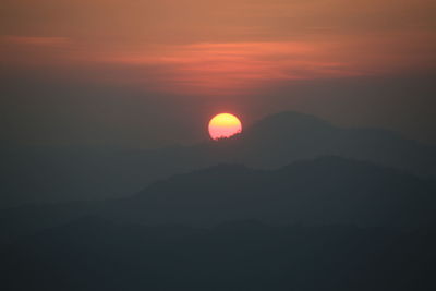 Scenic view of silhouette mountains against sky during sunset