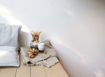 Black coffee and croissant on table at home