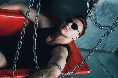 Woman sitting on swing at playground