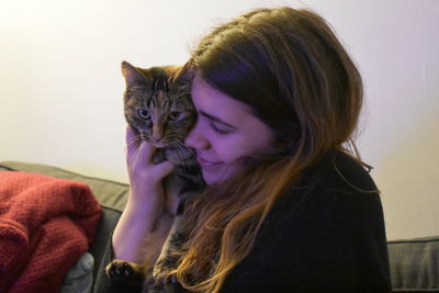 Young woman with cat at home