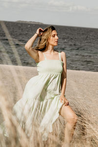 Young woman standing at beach