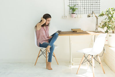 Woman sitting on chair at home