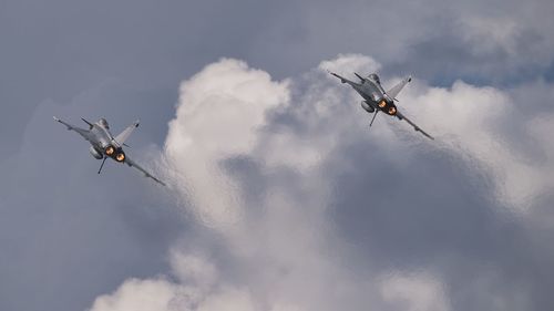 Low angle view of dassault rafale flying against sky