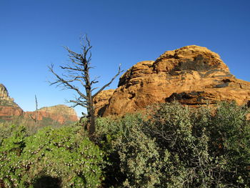 Rock formations against clear blue sky