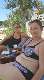 Portrait of young woman sitting outdoors