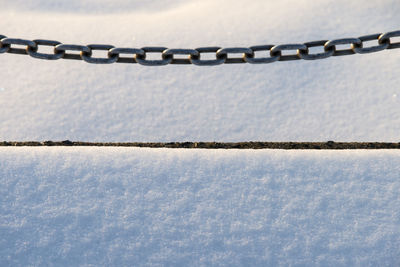 High angle view of chain over snow covered field