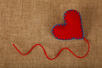 High angle view of heart shape on burlap