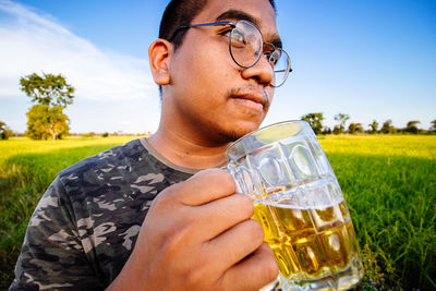 Midsection of man drinking beer glass