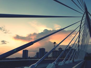 Silhouette bridge against sky during sunset