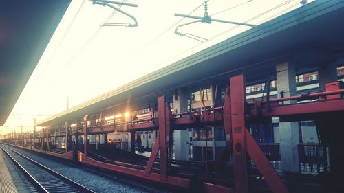 Train at railroad station against clear sky