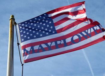 Low angle view of american flag against sky